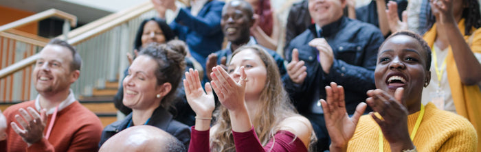 parents cheering during a meeting or assembly at a school